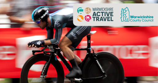 Image of a man cycling on a race bike with a helmet on. The image is slightly blurred because he