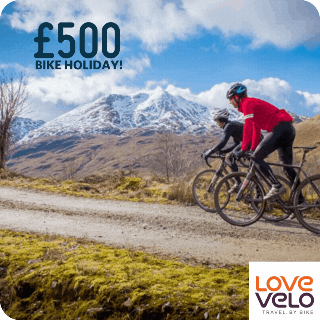 two people biking up a mountain, text says £500 Bike Holiday and Love Velo logo two people biking up a mountain, text says £500 Bike Holiday and Love Velo logo