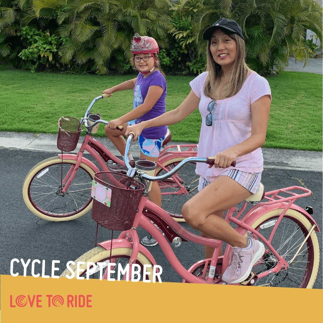A woman and a girl (they appear to be mother and daughter) pose on their matching pink shopper bikes and smile at the camera. The text says ‘Cycle September’ and the Love to Ride logo is displayed. A woman and a girl (they appear to be mother and daughter) pose on their matching pink shopper bikes and smile at the camera. The text says ‘Cycle September’ and the Love to Ride logo is displayed.