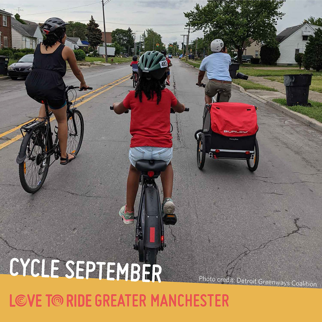 A family riding on a residential road, shown from behind. One person carries a trailer on their bike. The text says ‘Cycle September. Photo credit: Detroit Greenways Coalition’ and the Love to Ride logo is displayed. A family riding on a residential road, shown from behind. One person carries a trailer on their bike. The text says ‘Cycle September. Photo credit: Detroit Greenways Coalition’ and the Love to Ride logo is displayed.