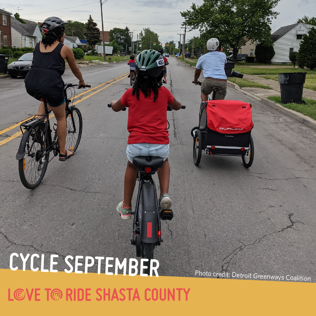 A family riding on a residential road, shown from behind. One person carries a trailer on their bike. The text says ‘Cycle September. Photo credit: Detroit Greenways Coalition’ and the Love to Ride logo is displayed. A family riding on a residential road, shown from behind. One person carries a trailer on their bike. The text says ‘Cycle September. Photo credit: Detroit Greenways Coalition’ and the Love to Ride logo is displayed.