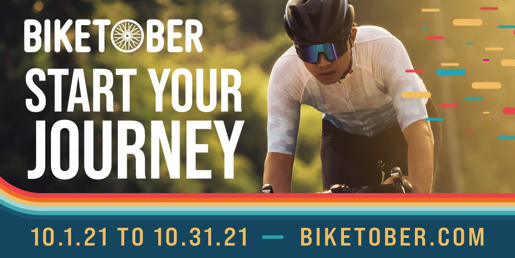 Rectangular graphic with text overlaid on a photo of a man riding a bike with a helmet and sunglasses. The text says "Biketober- Start your journey. 10.1.21 to 10.31.21, biketober.com" Rectangular graphic with text overlaid on a photo of a man riding a bike with a helmet and sunglasses. The text says "Biketober- Start your journey. 10.1.21 to 10.31.21, biketober.com"
