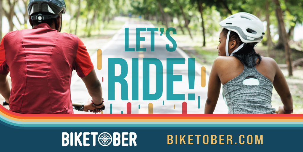 Rectangular graphic with text overlaid a photo of a man and a woman riding bikes. The text says "Let's Ride! biketober.com" Rectangular graphic with text overlaid a photo of a man and a woman riding bikes. The text says "Let's Ride! biketober.com"