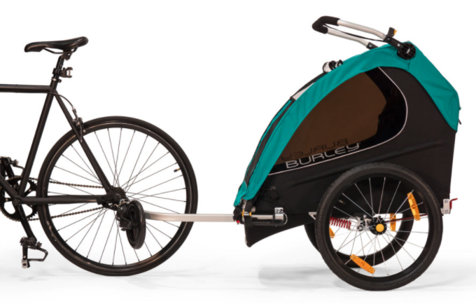 Burley Encore X kids bike trailor and double stroller with black wheels, silver handle bars and green and black material wrapped to cover for the trailor. Burley Encore X kids bike trailor and double stroller with black wheels, silver handle bars and green and black material wrapped to cover for the trailor.