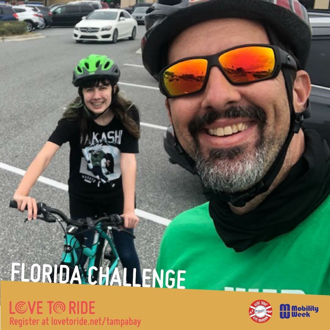A selfie of a man and child with bike helmets on, the man's helmet is patterned and the child's is green. The man also has sunglasses on and the child is on their bike. The text says 'Florida Challenge' with the Love to Ride logo beneath and the Alert Today and Mobility Week logo at the bottom right corner. A selfie of a man and child with bike helmets on, the man's helmet is patterned and the child's is green. The man also has sunglasses on and the child is on their bike. The text says 'Florida Challenge' with the Love to Ride logo beneath and the Alert Today and Mobility Week logo at the bottom right corner.
