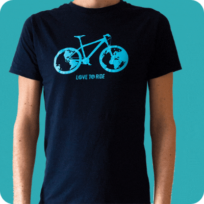 A model wearing a dark blue t-shirt with a light blue bike design on it and the Love to Ride logo. Inside the wheels of the bike is a Earth globe design. There is a sparkly animation around the edges. A model wearing a dark blue t-shirt with a light blue bike design on it and the Love to Ride logo. Inside the wheels of the bike is a Earth globe design. There is a sparkly animation around the edges.