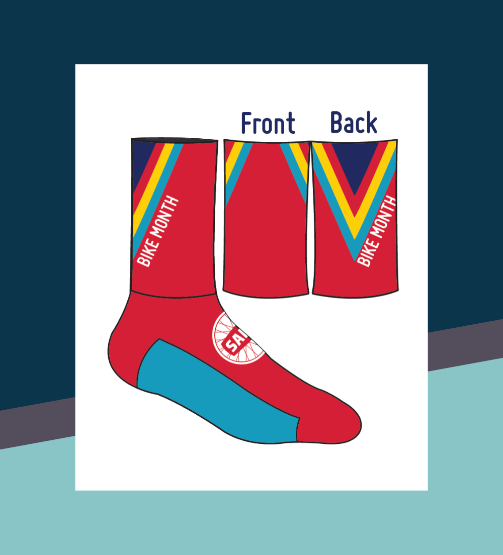an illustration of the may is bike month socks. They are red with turquoise bottoms. On the top of the foot there is a white SABA logo. On the top calf of the sock there is a multi colored V with the words Bike Month an illustration of the may is bike month socks. They are red with turquoise bottoms. On the top of the foot there is a white SABA logo. On the top calf of the sock there is a multi colored V with the words Bike Month