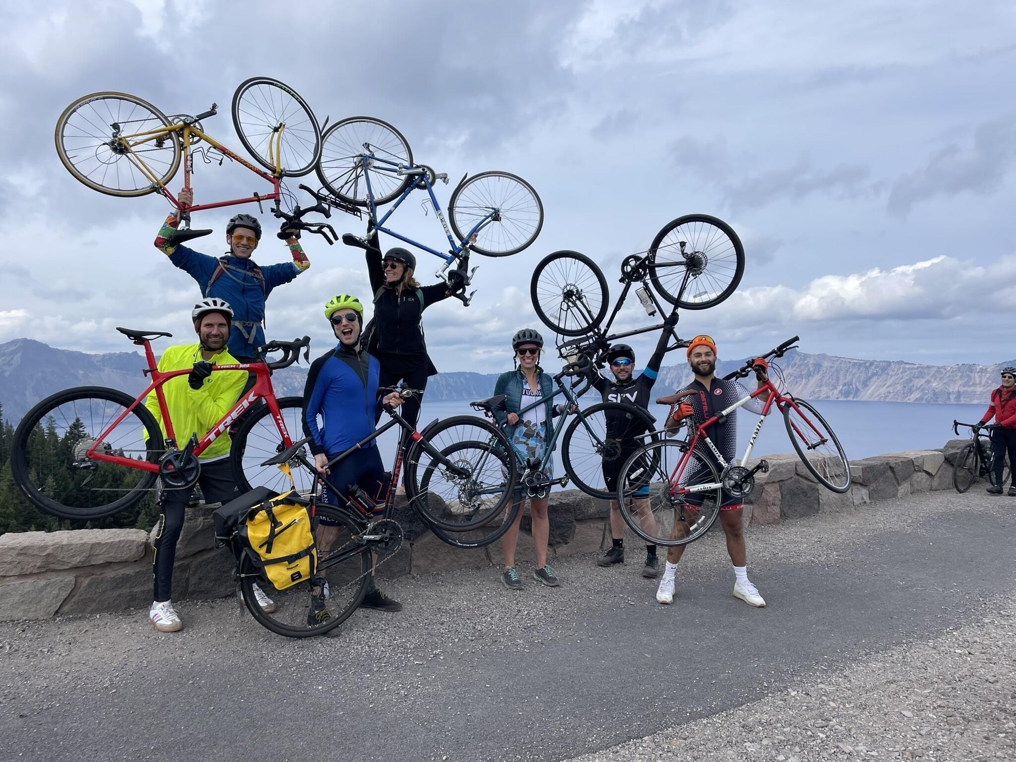 Happy riders holding their bikes up