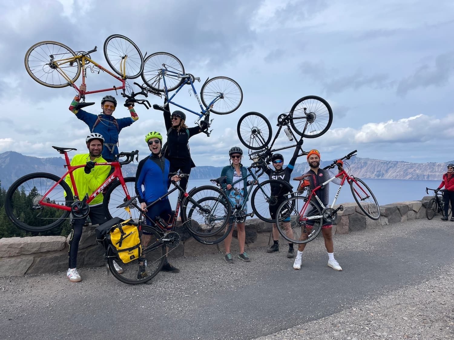 Happy riders holding their bikes in the air