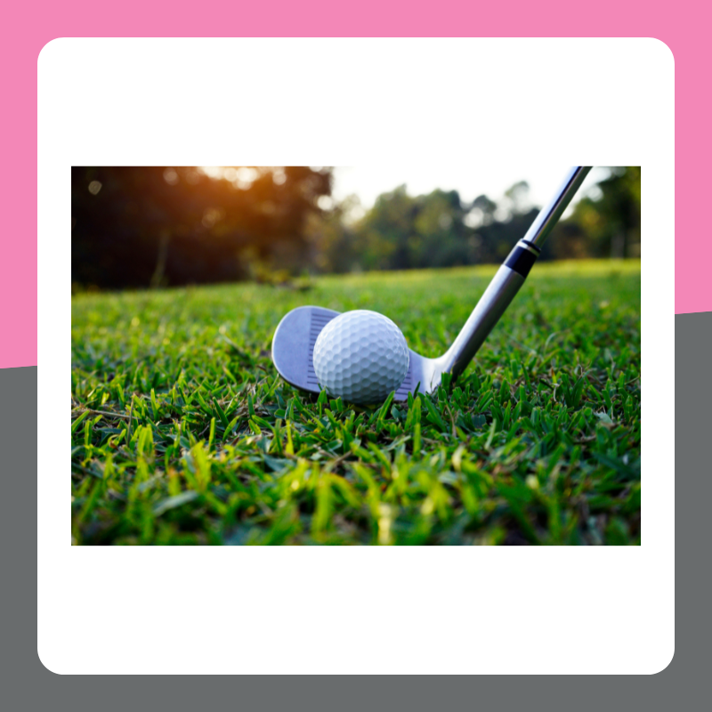 Image of a golf club hitting a golf ball on some grass. The image has a pink and grey border. 