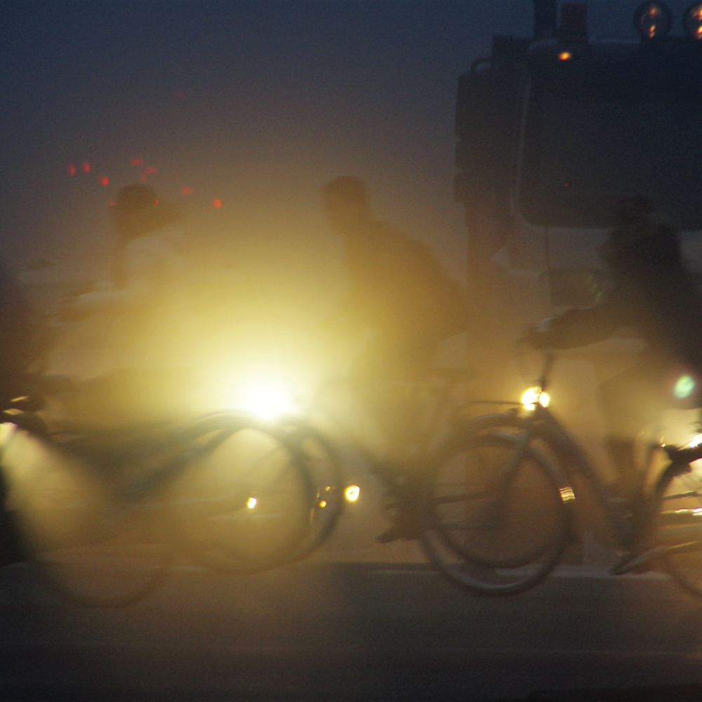 Bike rider in a snowy night setting with reflective strip around torso Bike rider in a snowy night setting with reflective strip around torso